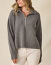 Women's Devon Half Zip Sweater in Woodland, front view on model featuring a grey quarter-zip closure and ribbed knit texture, styled with khaki pants