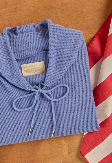 Folded Misty Top a tie-neck detail displayed beside an American flag, highlighting the Women's Made in USA Collection