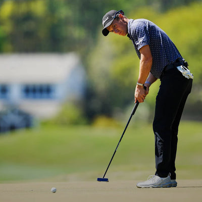 Tim Widing watching ball after he hit the putt on the green wearing Straight Down